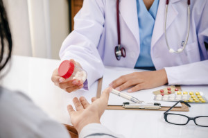 close up of doctor giving medicine to patient