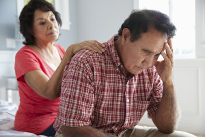 Wife Comforting Senior Husband Suffering With Dementia