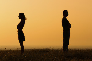 Silhouette of a angry woman and man on each other.