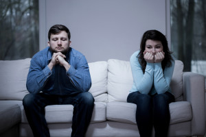 Couple after argument sitting on the sofa