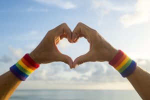 hands wearing lgbtqi pride rainbow colors